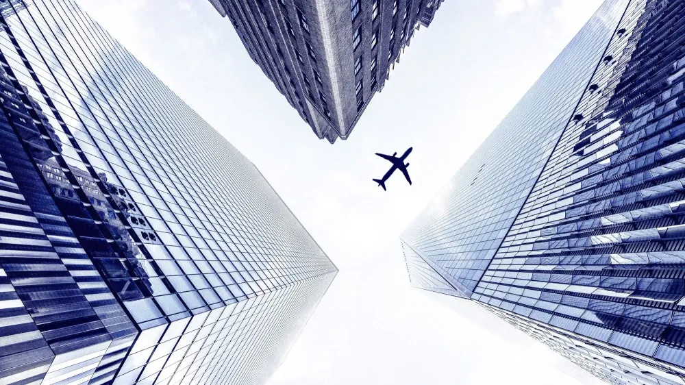 airplane over skyscrapers